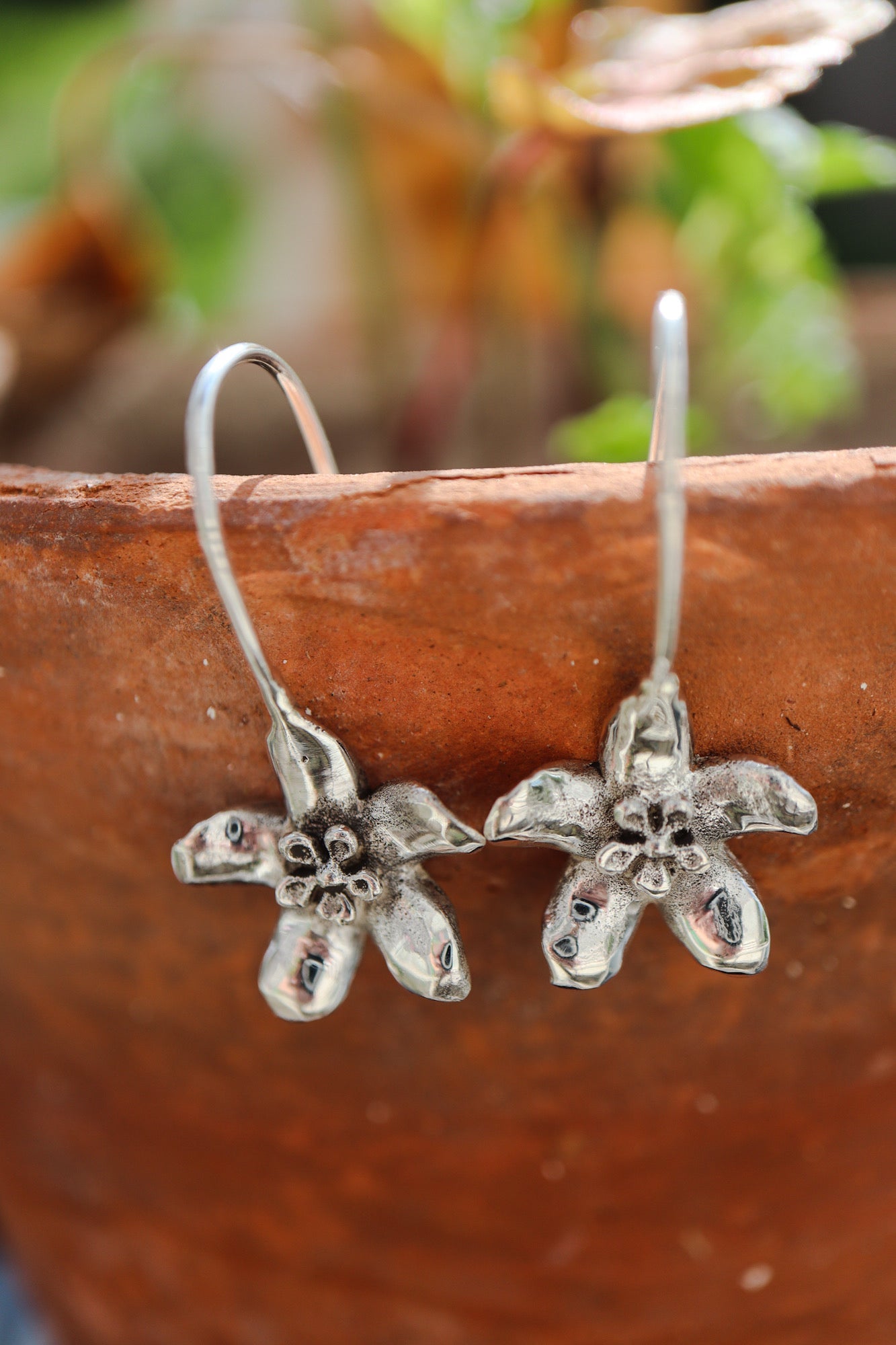 Solid Sterling Silver Hoya flower drop earrings.